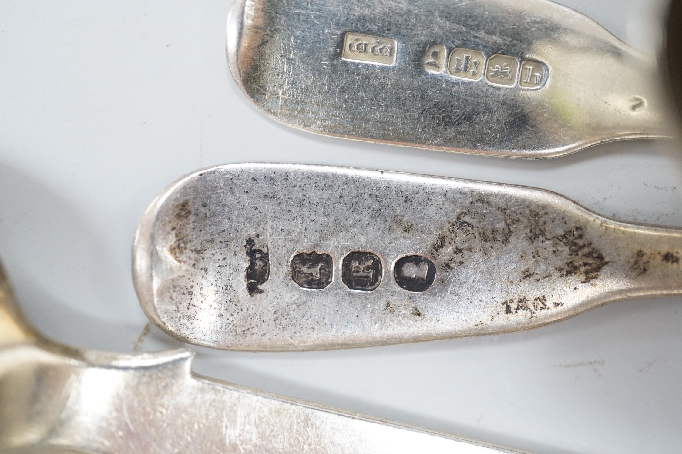 A cased set of twelve George V pierced silver teaspoons, with tongs, Sheffield, 1910, one other cased set of six silver bean end coffee spoons and eleven assorted mainly 19th century silver teaspoons.